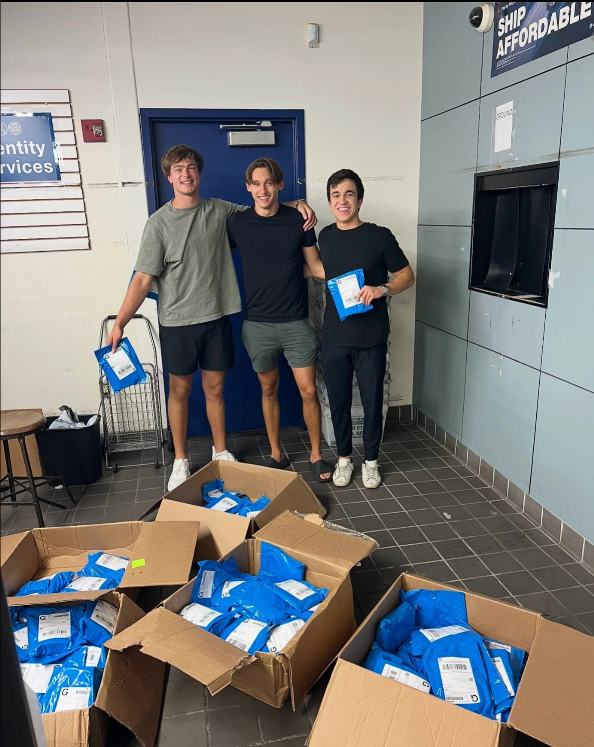 Electro co-founders with shipping boxes of product orders