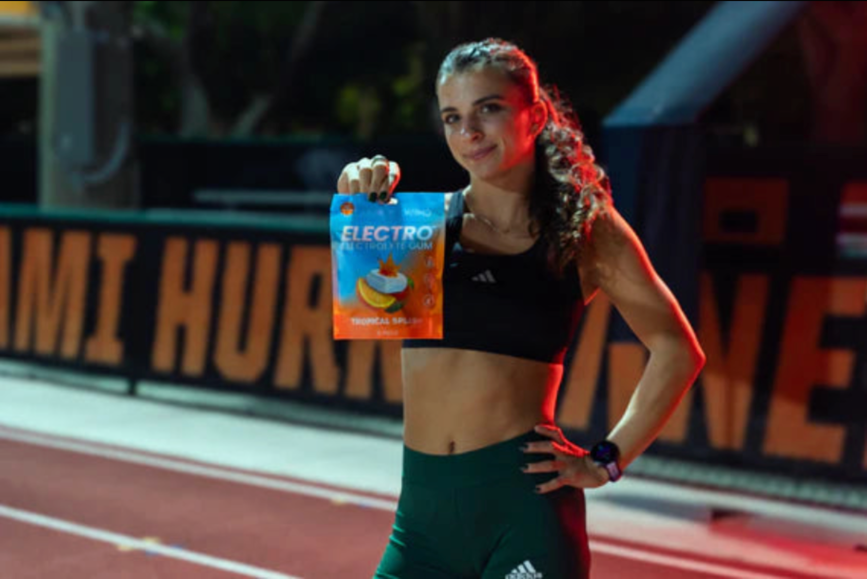 Electro athlete holding the Tropical Splash pouch on the track