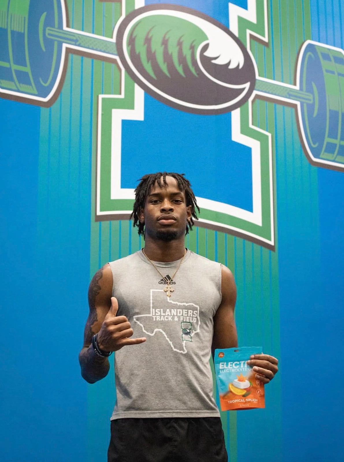 Islanders Track and Field athlete giving thumbs up with Electro Gum pack