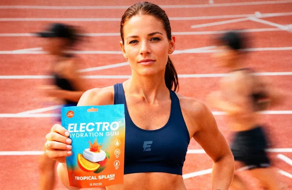 Track athlete holding the Electro pouch with motion-blurred runners behind her
