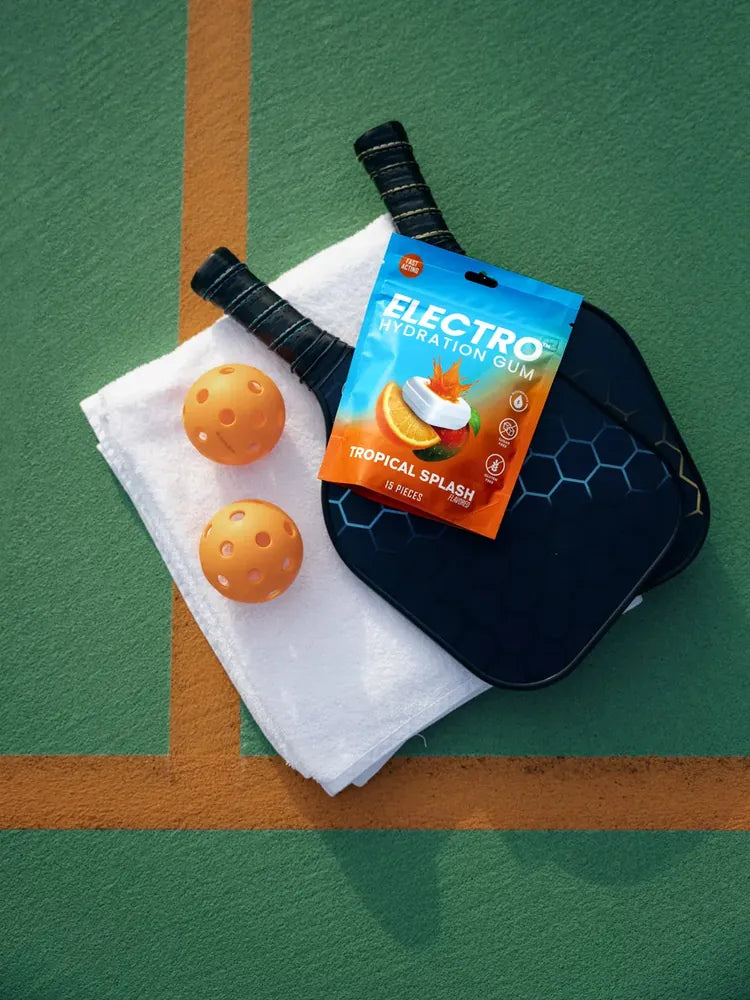 Electro pouch on pickleball paddles and orange balls courtside